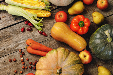 Beautiful composition with autumn vegetables on weathered wooden background