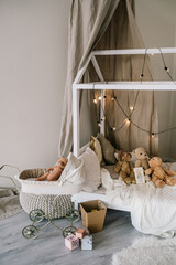 Fototapeta na wymiar Baby cot in beige color. Children's room interior design in new Year's style
