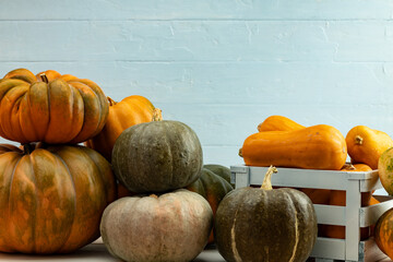 Pile of pumpkins in a wooden box