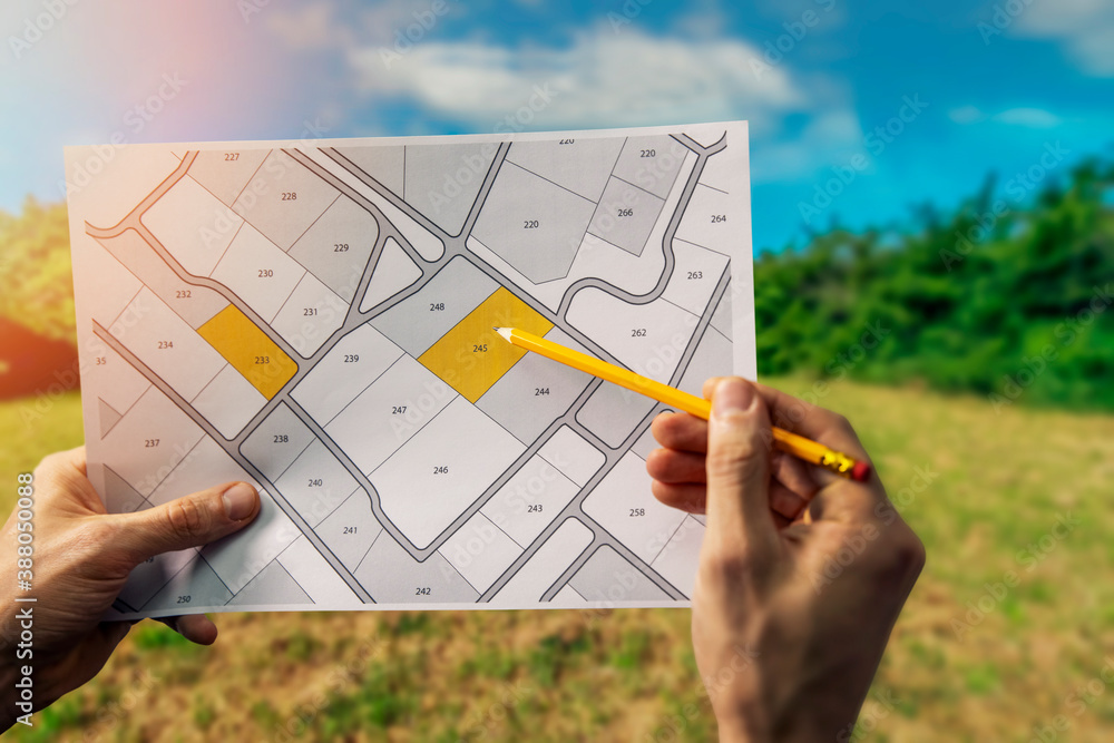 Wall mural sale of building plot of land for house construction. cadastral map on field background
