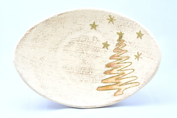 toys for Christmas tree, festive plate, stand decorated with Golden Christmas tree and stars