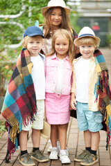 portrait of multi-ethnic children keen on nature, spending time in garden or hothouse, greenhouse. harvest, plants and living beings creatures around