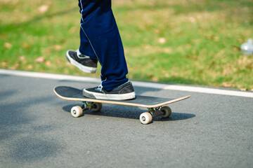Cropped view of skateboarder skateboarding at skatepark.
