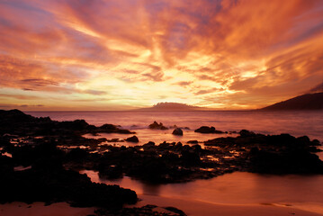 Sunset glow on lava rock tide pools at Kihei Maui