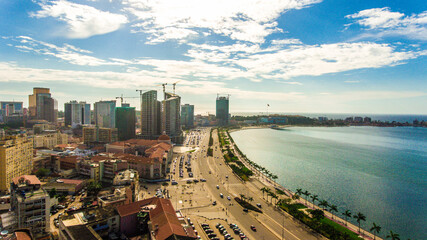 Fototapeta na wymiar Road, lights and sea at night. Luanda city captured from the top