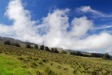 Clouds rolling down the side of Haleakala volcano in Maui