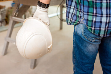protective helmet in the hand of a worker