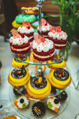 
Original cap cake on a festive dessert table. Candy bar. Delicious holiday reception on dessert table. Festive table with a variety of sweets. Sweet table with desserts for the holidays.