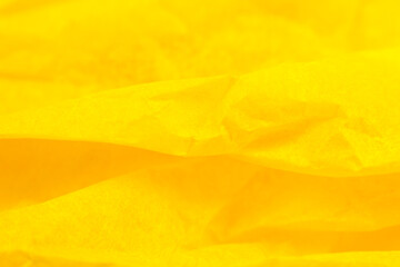 Fototapeta premium Crumpled yellow paper background. Real macro battered texture. Close up photo.