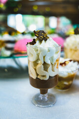 A variety of colored desserts in a glass. Colorful jelly dessert in a glass. Multicolored cream dessert in a glass.