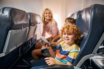 Cheerful child playing with a toy airplane