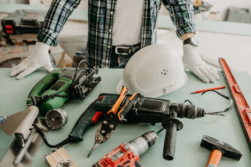 Construction worker in a house with construction tools