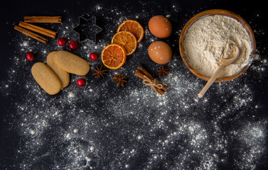 Fototapeta na wymiar Christmas Baking background. Ingredients for cooking christmas baking on dark stone or metal background. Top view with copy space.