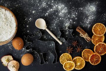 Christmas Baking background. Ingredients for cooking christmas baking on dark stone or metal background. Top view with copy space.