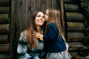 A lovely young girl kissing mother