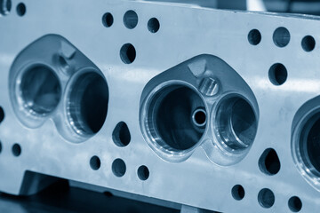 Close-up scene of aluminum cylinder head. The automotive parts manufacturing concept.