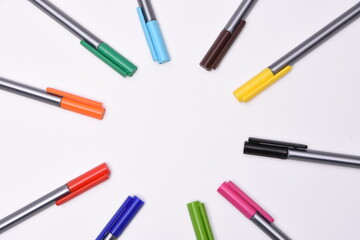 Сolored markers on the tables with notebooks