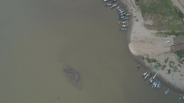 Fishermen boat from the air on polluted Tonle Sap in Phnom Penh