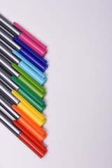 Сolored markers on the tables with notebooks