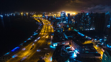 Road, lights and sea at night.
Luanda city captured from the top