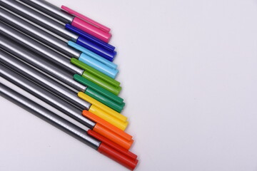 Сolored markers on the tables with notebooks