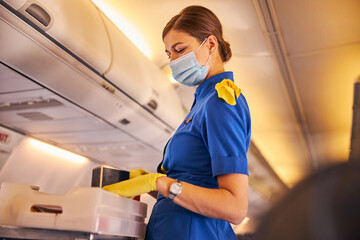 Air stewardess handing out food from a tray