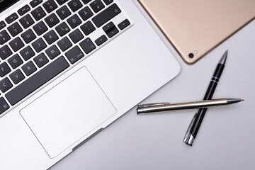 Business place with laptop, pad and pen