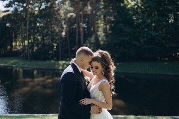 Naklejka premium Walk of the bride and groom in the summer garden.