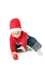 Baby in Santa hat playing with Christmas balls, isolated on white