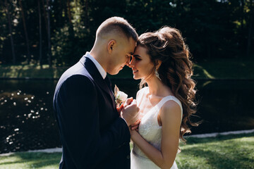 Walk of the bride and groom in the summer garden.