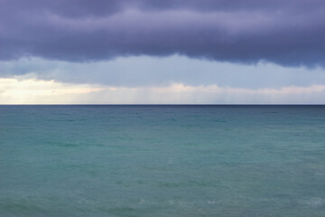 Stormy skies above the sea at sunset time.