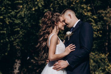 Photo session of the newlyweds against the backdrop of a picturesque area. Forest and rocks.