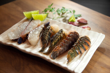 Raw lobster tails cut in half ready to grill. Selective focus.
