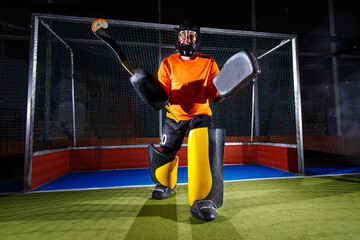 Field hockey goalie at the net ready to defense