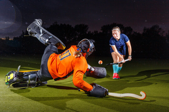 Young Field Hockey Player Attacks The Goalkeeper