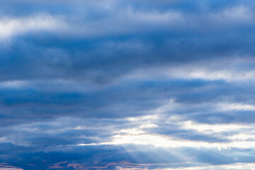 blue sky background with white clouds sun rays autumn day