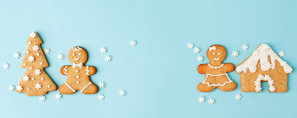 Happy New Year's Christmas set of ginger biscuits - man, house, tree glazed sugar icing decoration on blue background, minimal seasonal winter holiday card, banner, flyer, coupon, stay home