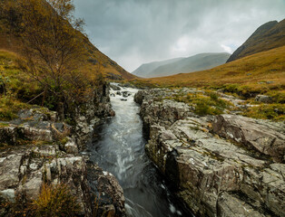 long exposure shot of the waterfalls in glen etive near loch etive and the entrance to glencoe and rannoch moor in the argyll region of the highlands of scotland during autumn