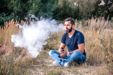 Handsome vape man smoking an vape. Getting rid of nicotine addiction.