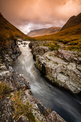long exposure shot of the waterfalls in glen etive near loch etive and the entrance to glencoe and rannoch moor in the argyll region of the highlands of scotland during autumn