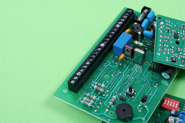 Electronic printed circuit boards on a green background. Recycling of electronic waste and...