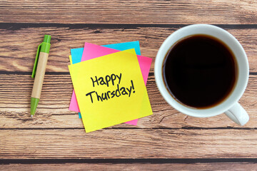 Happy Thursday quotes on paper note with cup of coffee and pen
