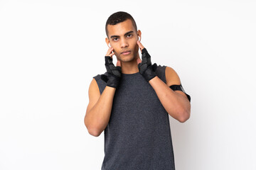 Fototapeta premium Young African American sport man over isolated white background listening music