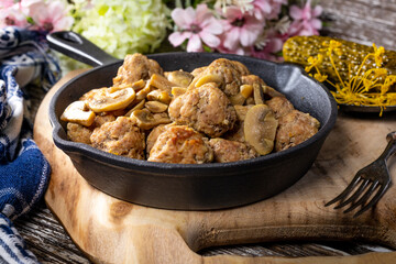 Meatballs served with pickled cucumber.
