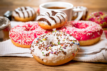 Sweet donuts, donut and cup of coffee on table, sweet plaeasure