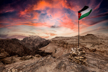 jordan flag on the mountains near petra. - obrazy, fototapety, plakaty