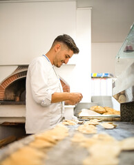 Young chef is making handmade dumplings. Concept of good, genuine and healthy cuisine