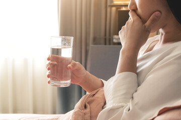 sick women hand hold a glass of water, healthcare and medicine r