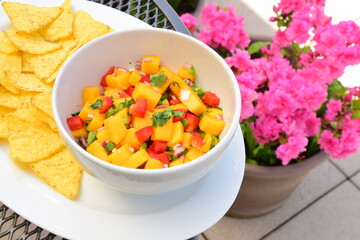 Mango salsa in a bowl with tortilla chips