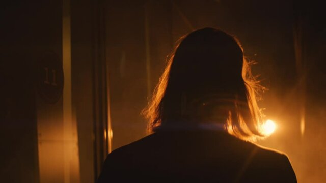 long hair man walks in the spotlight